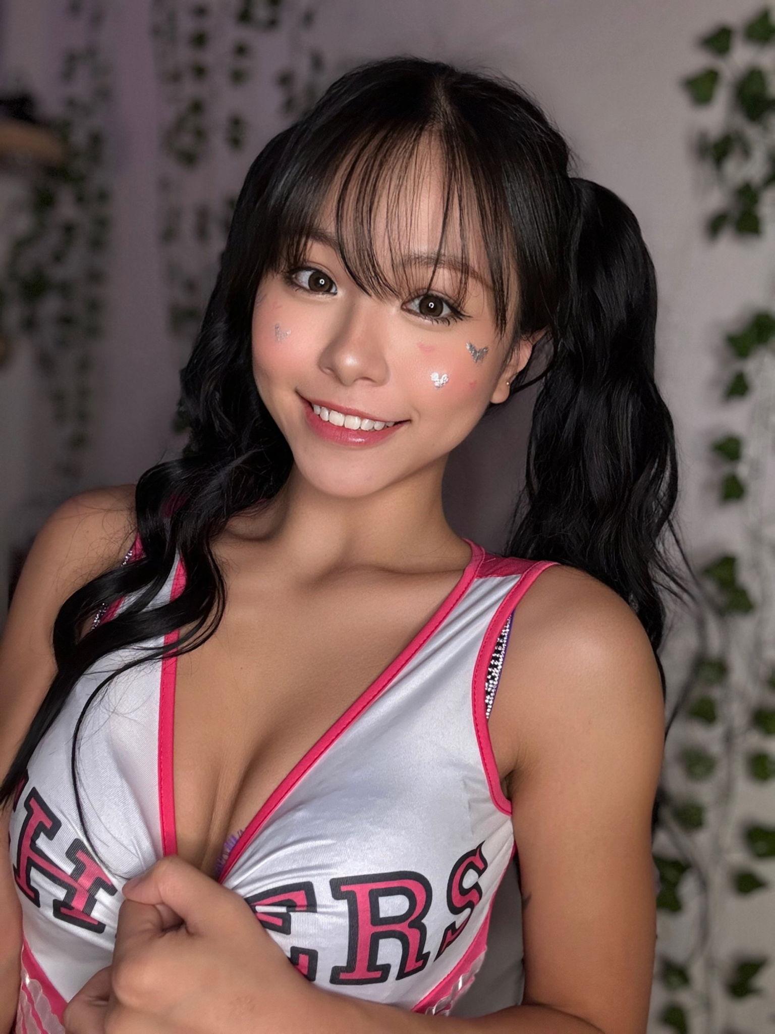 Asian girl in a cheerleader outfit smiling